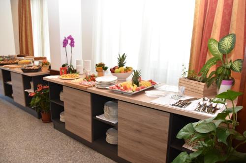 a buffet line with plates of food and fruits at Hotel Excelsior in Montesilvano