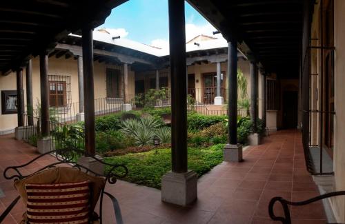 a porch with a bench in a building at Camino Real Antigua in Antigua Guatemala