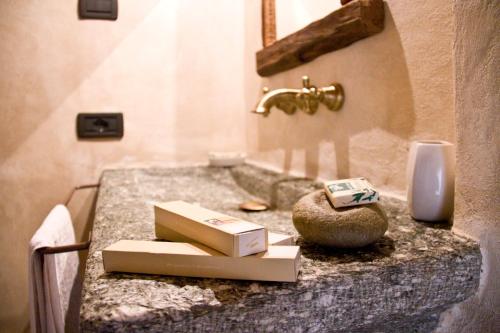 a bathroom counter with a box on top of it at Contrada Beltramelli in Villa di Tirano