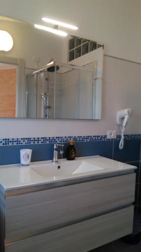 a bathroom with a sink and a mirror at Viola di Mare Rooms and Parking in Termoli