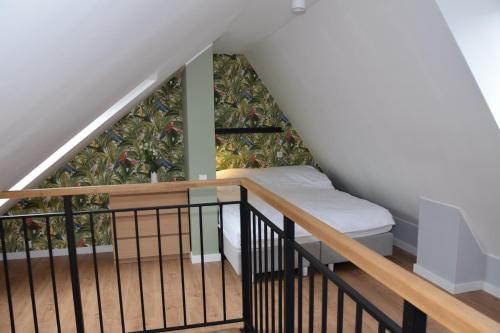 a room with a staircase with a bed on it at VerrAri Apartaments in Łeba