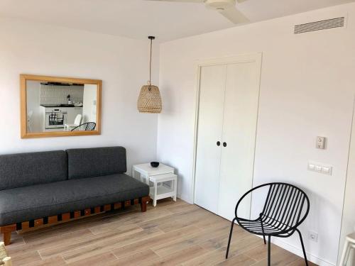 a living room with a couch and a chair at Ses Terrasses in Cadaqués