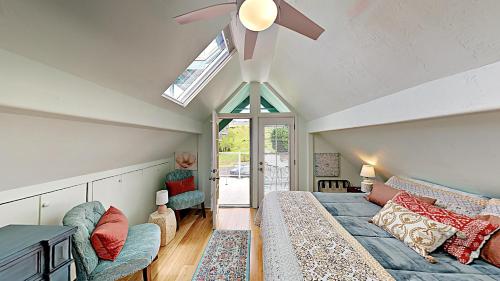 a attic bedroom with a bed and a ceiling fan at Ha'le Kiana in Kula