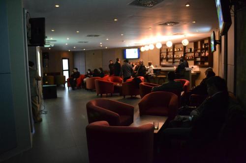 a group of people sitting in a waiting room at Hotel Calacoto in La Paz