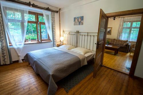 a bedroom with a bed and a large window at Willa Anna in Szklarska Poręba