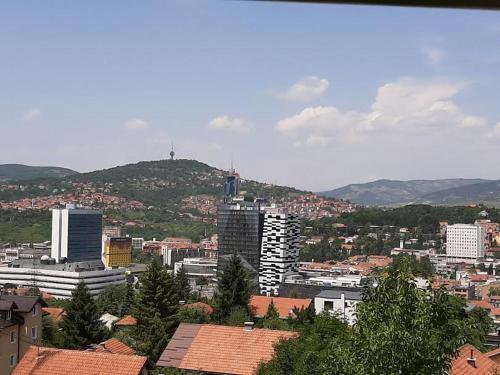 a view of a city with buildings and trees at Guesthouse Hill in Sarajevo