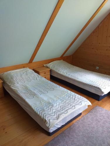 two beds in a room with a attic at Zawojka in Zawoja