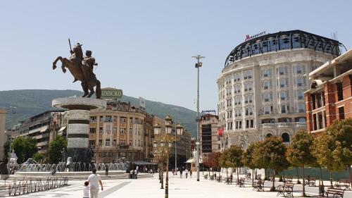 a city with a statue of a man on a horse at Hotel Square in Skopje