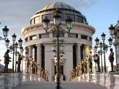 a building with a bunch of statues in front of it at Hotel Square in Skopje