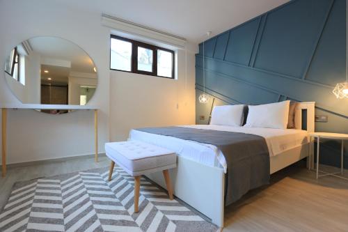 a bedroom with a large bed and a mirror at Verde Suites Akyaka in Akyaka