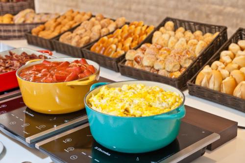 a buffet of different types of food on a table at Hotel Panamby São Paulo in Sao Paulo