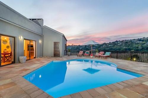 a large blue swimming pool on a patio at 47th on Howard in Knysna