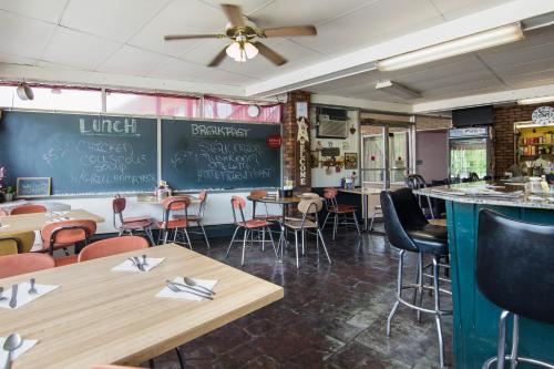 a restaurant with tables and chairs and a chalkboard at Knights Inn Amsterdam in Amsterdam