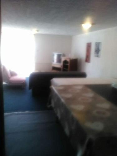 a blurry picture of a room with a bed and a window at Gogo location 1 in Forest-Saint-Julien