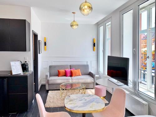 a living room with a couch and a table at LIFE CATHEDRALE City-Center Place Gutenberg in Strasbourg