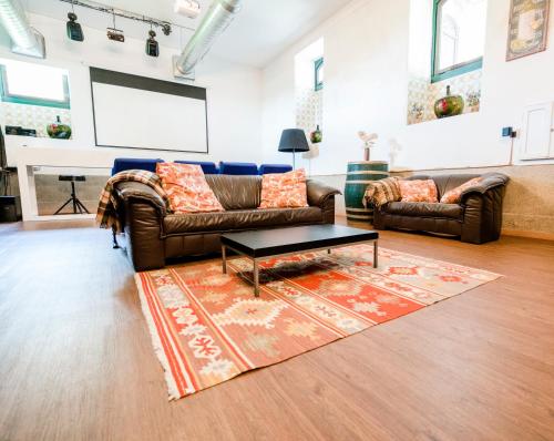 a living room with two couches and a table at Palacete Villa Idalina in Caminha
