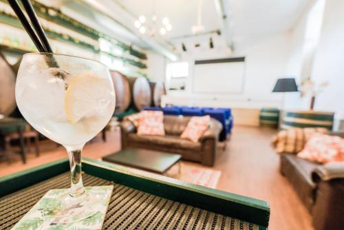 a wine glass sitting on a table in a living room at Palacete Villa Idalina in Caminha