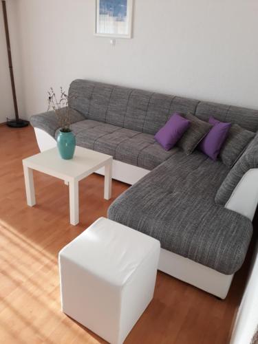a living room with a couch and a table at Apartment Bellavita Senj in Senj