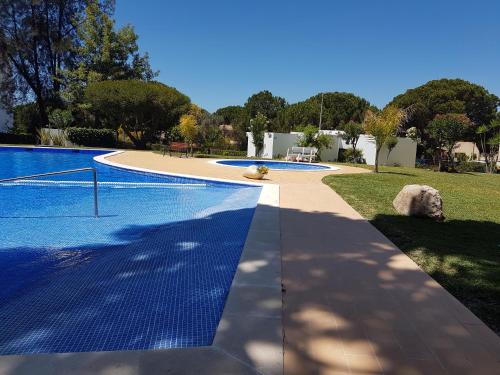 a swimming pool with blue tiles on the ground at Penthouse with panoramic view in Vilamoura