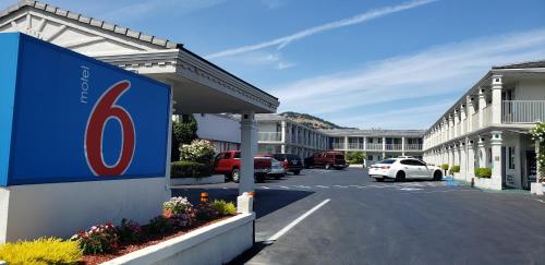 a building with a sign in front of a parking lot at Motel 6 San Rafael in San Rafael