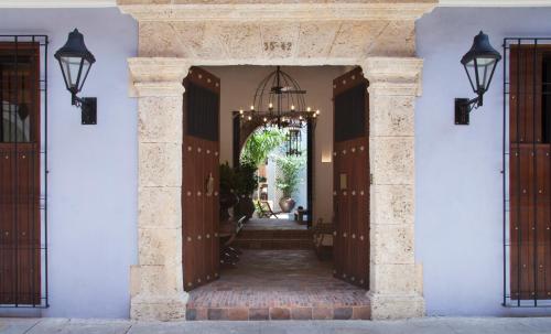 an entrance to a house with a hallway with doors at Casa de la Renta By Mustique in Cartagena de Indias