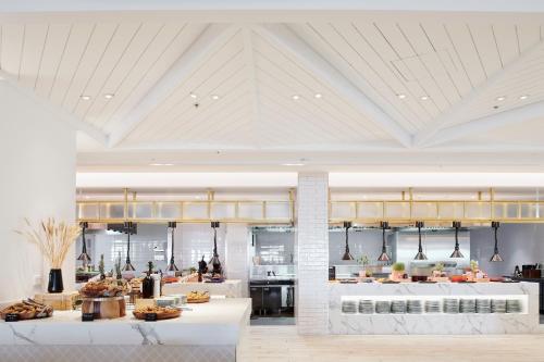 a restaurant with a counter with food on it at The Ville Resort - Casino in Townsville