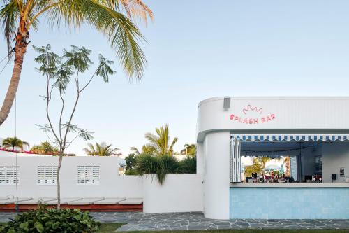 a view of a building with a palm tree at The Ville Resort - Casino in Townsville