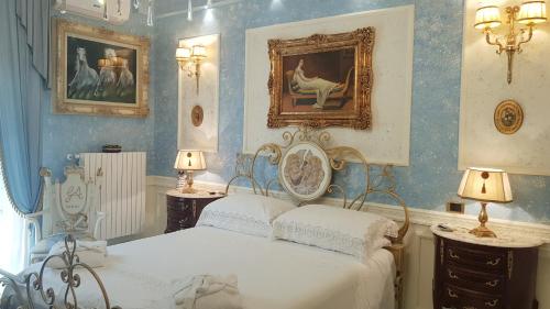 a bedroom with two beds and paintings on the walls at Luxury B&B IL Sogno in Cerignola