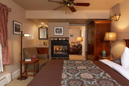 a bedroom with a bed and a fireplace at Lake Pointe Inn in McHenry