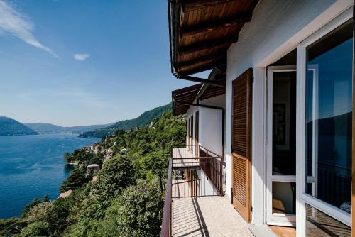 a balcony of a house with a view of the water at Villa Fantastica in Carate Urio