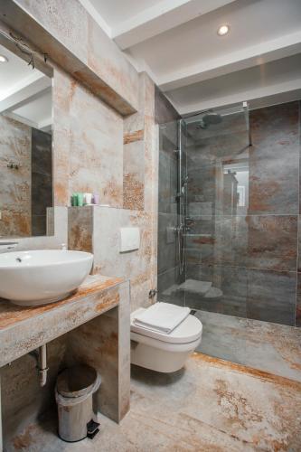 a bathroom with a sink and a toilet and a shower at Boutique Room Kaliopi in Hvar