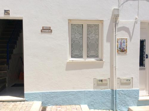 a white building with a window on the side of it at Casa Alzira By ALzira in Albufeira