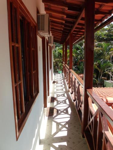 a porch of a house with wooden windows at Pousada Horizonte dos Borbas in Abraão