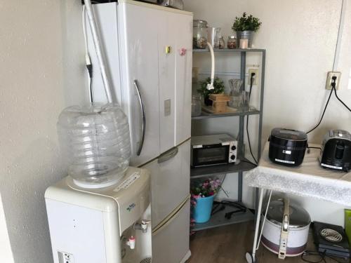 a kitchen with a refrigerator and a blender at Chiba Green hills Inage #8Mx in Chiba
