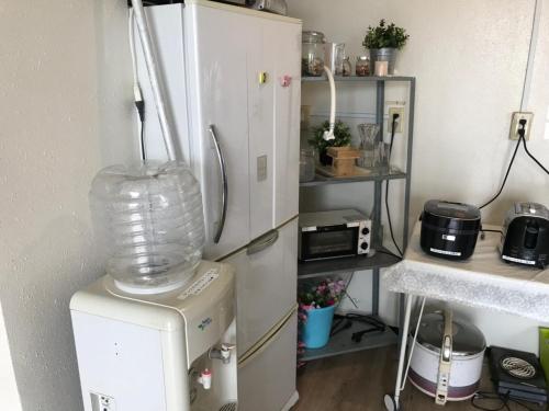 a kitchen with a refrigerator and a blender at Chiba Breen hills Inage #8Mx in Chiba