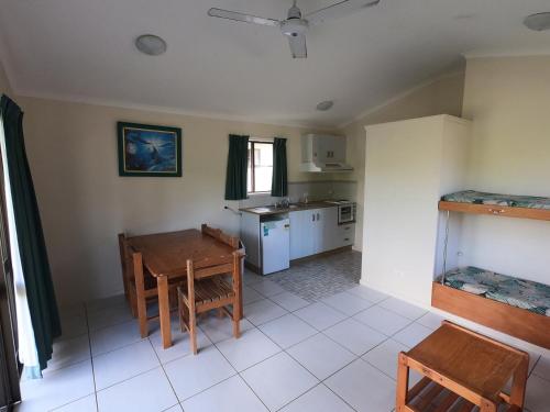 a kitchen with a table and chairs in a room at Halliday Bay Resort in Seaforth