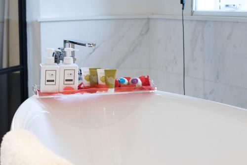 a bathroom sink with a shelf on top of it at Hotel NuVe Urbane in Singapore