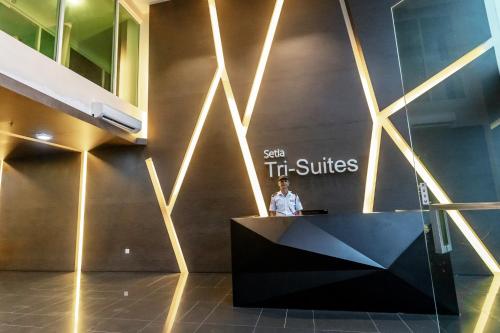 a man standing at a podium in a building with a sign that reads spin t at Cozy Home with Spectacular View in Bayan Lepas