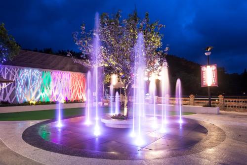 a fountain with lights in front of a building at Sun Moon Lake Hotel in Yuchi