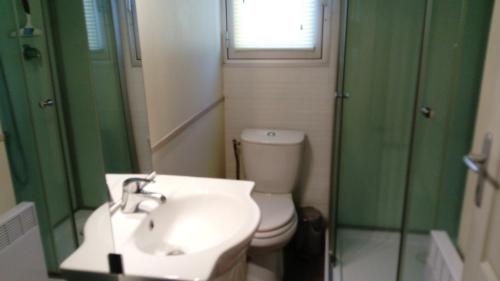 une salle de bain avec un lavabo, des toilettes et une douche dans l'établissement camping le pavillon, à Sigean