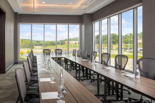 a large conference room with a long table and chairs at The Summit Hotel in Cincinnati