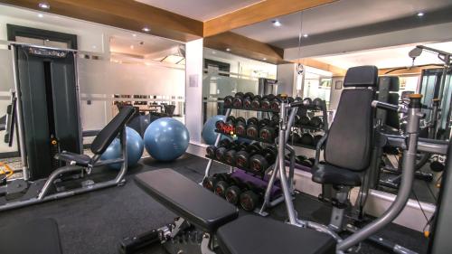 a gym with several tread machines and a mirror at BYD Lofts - Boutique Hotel & Serviced Apartments - Patong Beach, Phuket in Patong Beach