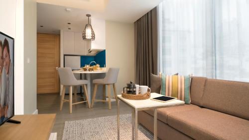 a living room with a couch and a table at Citadines Cebu City in Cebu City