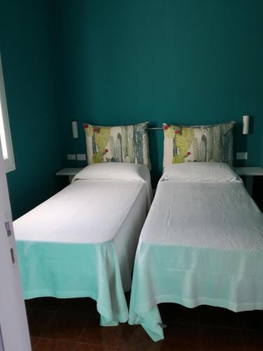 two beds sitting next to each other in a room at TramontanaBeach in Tracino