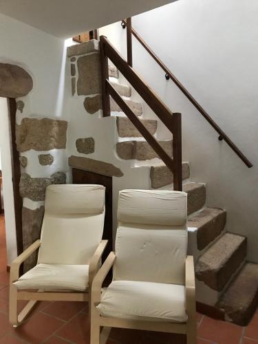 two chairs sitting in front of a staircase at Casa do Ferreiro in Tolosa