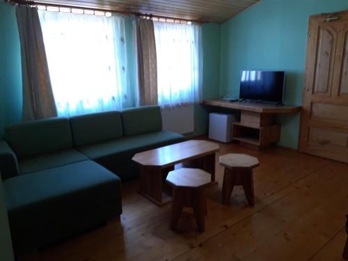 a living room with a couch and a table at Penzión Weinerovka Varín in Žilina