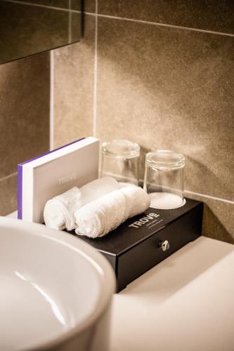a box with towels and glasses on top of a sink at TROVE Johor Bahru in Johor Bahru