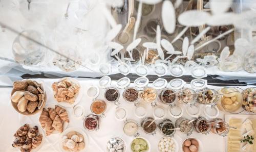 a display of different types of cookies and other foods at Hotel Krondlhof in Brunico