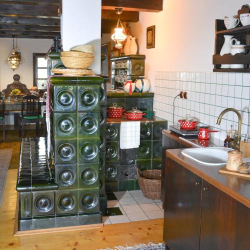 a kitchen with green cabinets and a sink at Vinum Vidae in Lendava