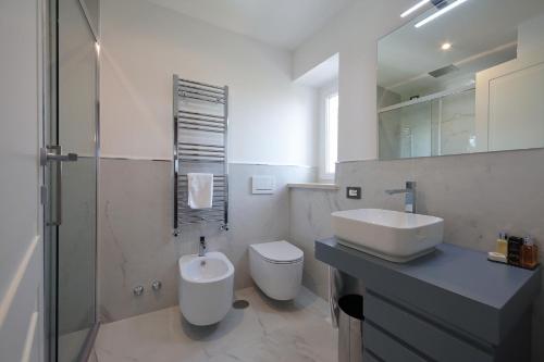 a white bathroom with a sink and a toilet at Residenza Palazzo Fortuna - Boutique Hotel in Civita Castellana